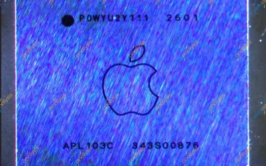 Close-up of a small blue chip with an Apple logo and part markings on its lid