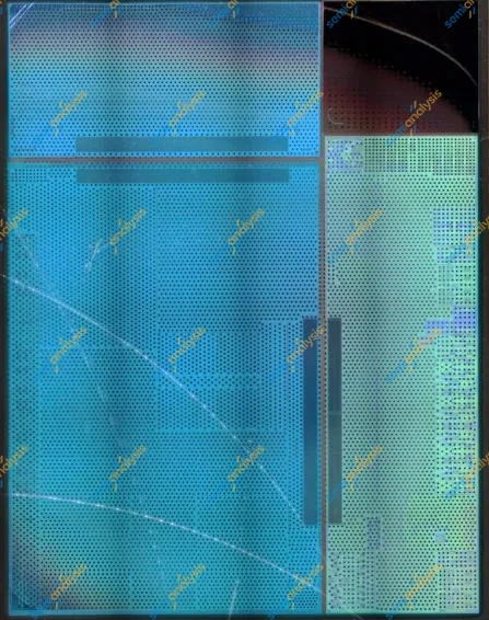 Blue-tinted optical image of a die surface with a dense grid of bumps and a darker block to one side