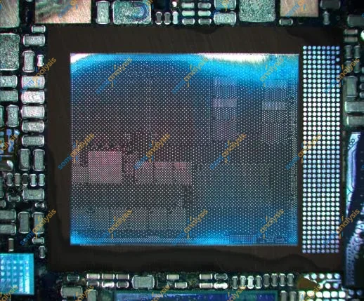 Optical image of a blue package sitting among rows of small components on a circuit board