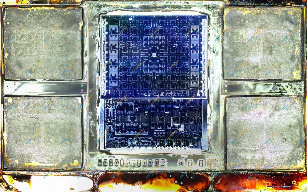 Opened Apple M5 Max package showing a blue logic die between four memory stacks, with epoxy residue around the edges